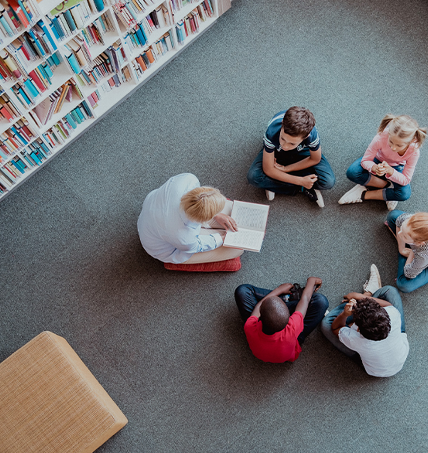 group of kids in library with teacher group of kids in library with teacher