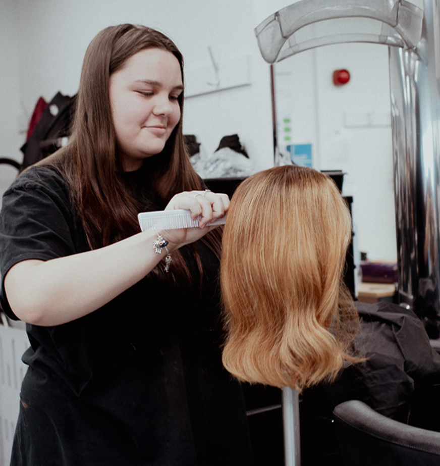 student working on mannequin hair 