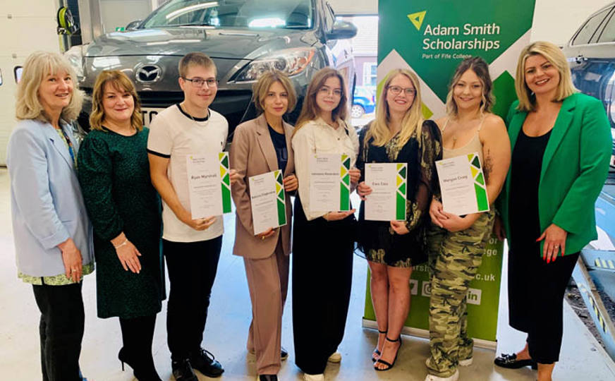group of arnold clark scholarship winners holding certificates smiling at camera