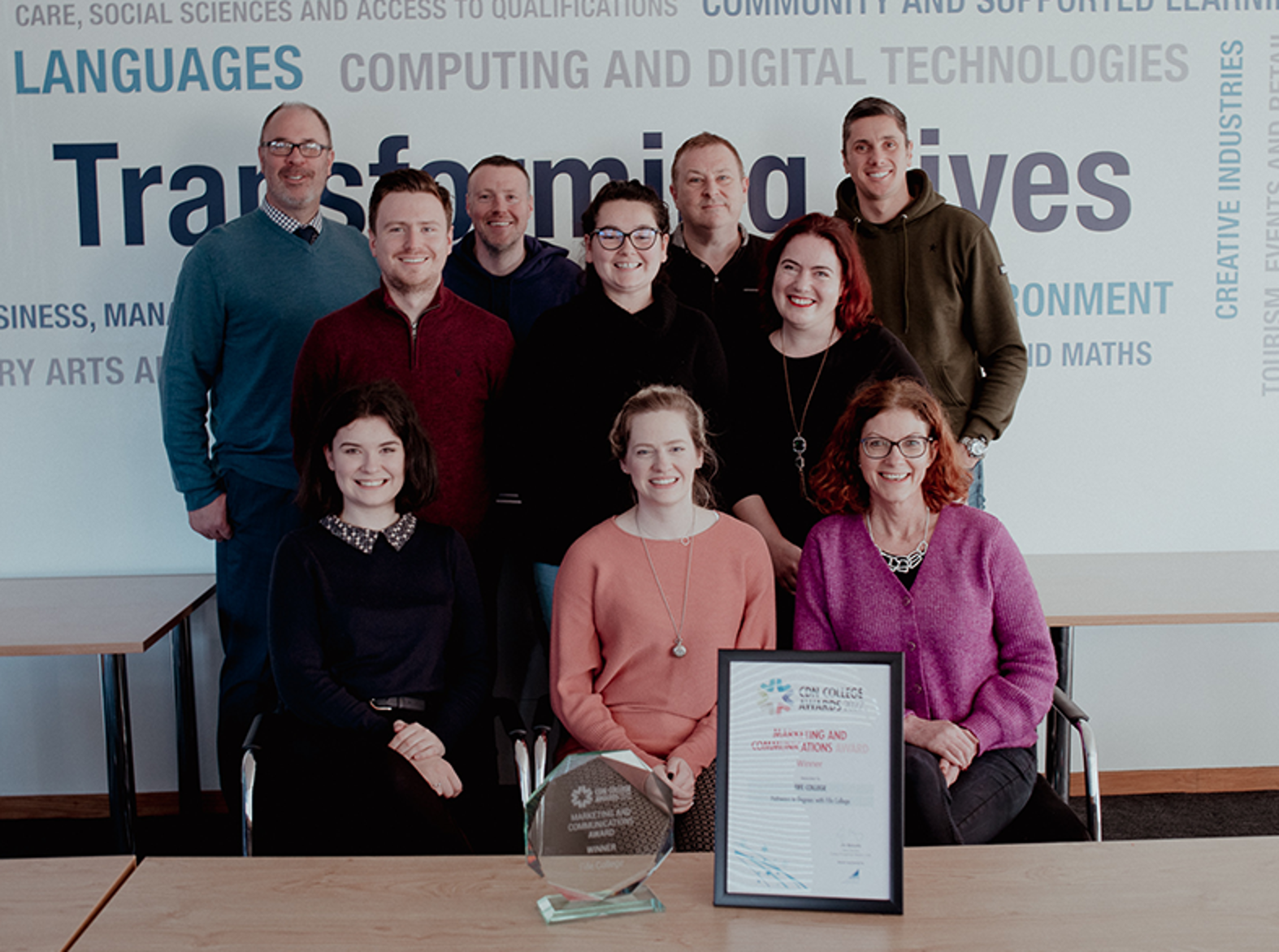 fife college marketing team smiling at camera with award