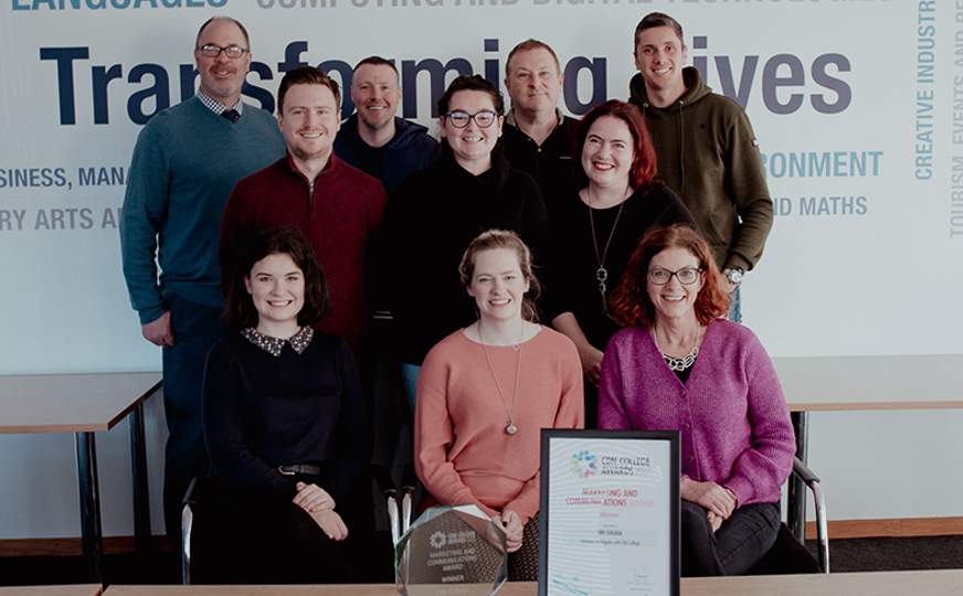fife college marketing team smiling at camera with award