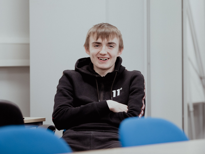 male pupil smiling at camera