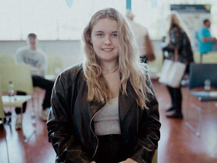 female student smiling at the camera in refectory