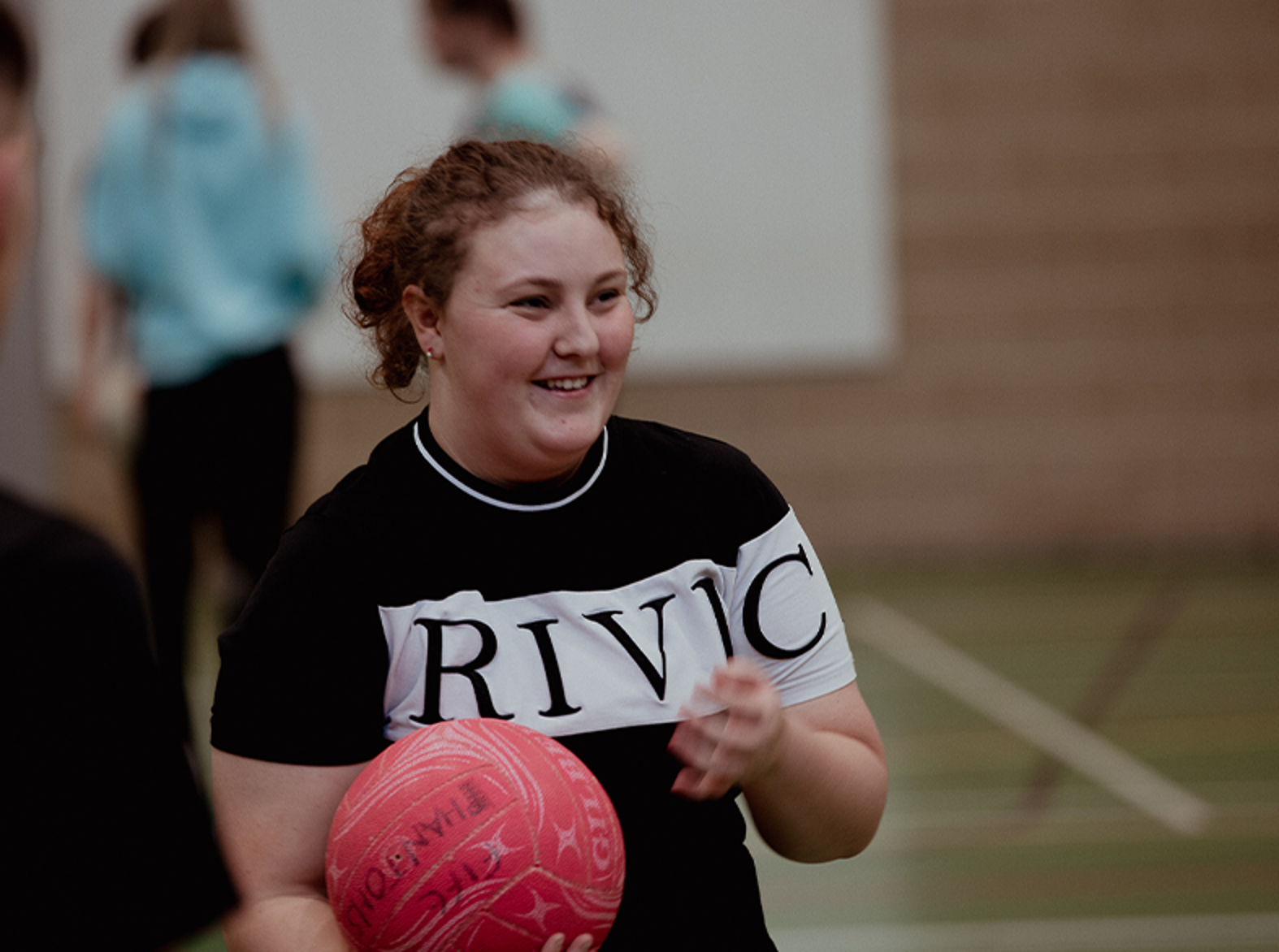 female sports student holding basketball
