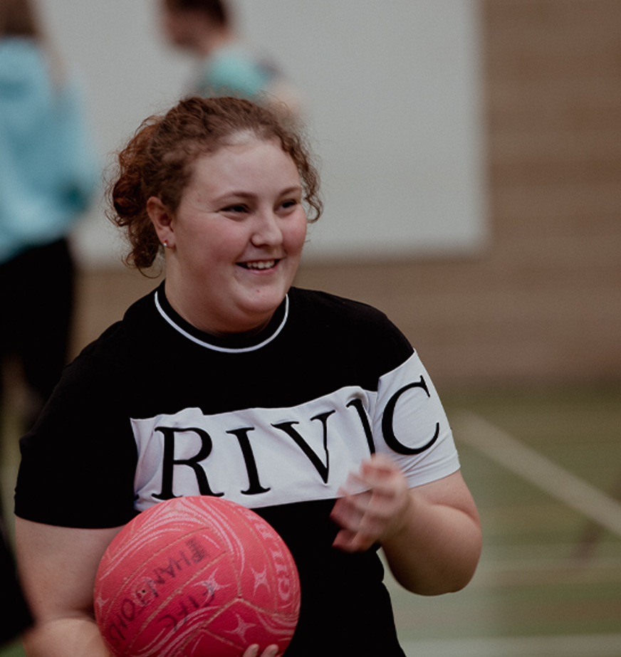 female sports student holding basketball